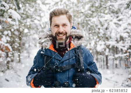 Cheerful Tourist Smiling in Winter Snow-clad Forest Cheerful Tourist Smiling in Winter Snow-clad Forest 62385852