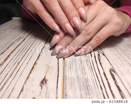 Gray striped nail design on female hand close up. Gray striped nail design on female hand close up. 62388618