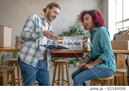 Young man and girl discussing work issues. 62389006