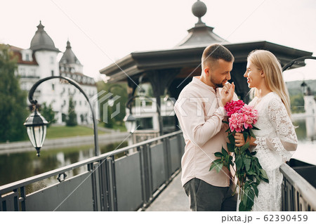 Beautiful couple spend time in a summer garden 62390459