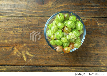 Ripe gooseberry in a glass plate, place for text, 62406655