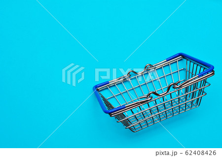 Blue shopping cart or trolley on blue background, buy and sale concept. Blue shopping cart or trolley on blue background, buy and sale concept. 62408426