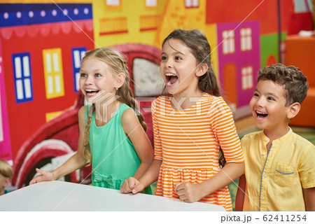 Three emotional kids in playroom. Three emotional kids in playroom. 62411254