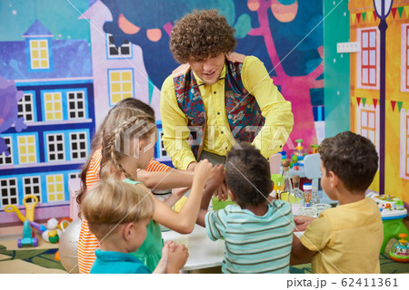 Animator with happy children indoor. 62411361