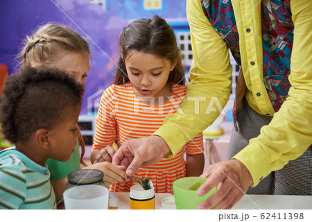 Kids doing a chemical experiment in playroom. 62411398