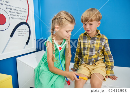 Cute little kids playing doctor and patient. 62411998