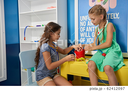 Kids playing doctors at medical office. Kids playing doctors at medical office. 62412097