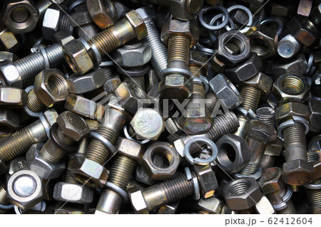 Сlose up of bright and shiny nuts, bolts and washers. Industrial background. 62412604