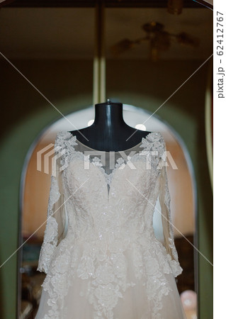 Beautiful wedding dress on a hanger on a happy 62412767