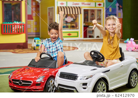 Two kids having fun in entertainment center. 62412970
