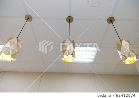 Three beautiful chandeliers on the ceiling in a Three beautiful chandeliers on the ceiling in a 62412974