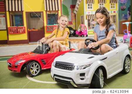 Kids drive car in entertainment center. Kids drive car in entertainment center. 62413094