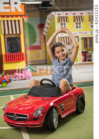 Cheerful little girl playing at kids entertainment center. 62413153