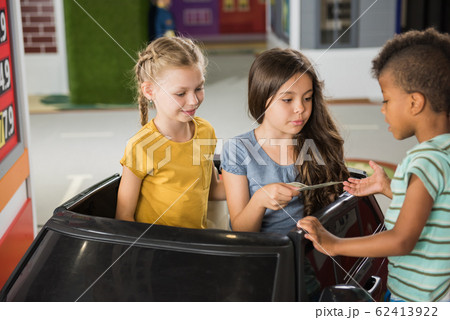 Kids playing gas station in playroom. 62413922