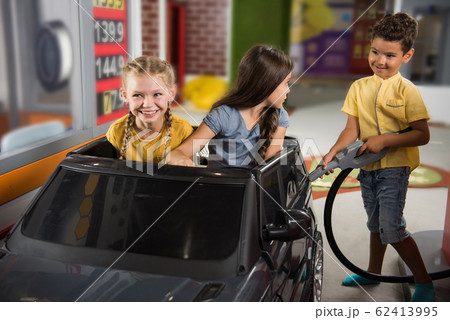Kids at a gas station. Kids at a gas station. 62413995