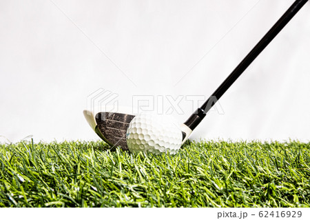 A golf club that is played by people hitting a golf ball on an artificial grass. Green means being ready for the game of golf A golf club that is played by people hitting a golf ball on an artificial grass. Green means being ready for the game of golf 62416929