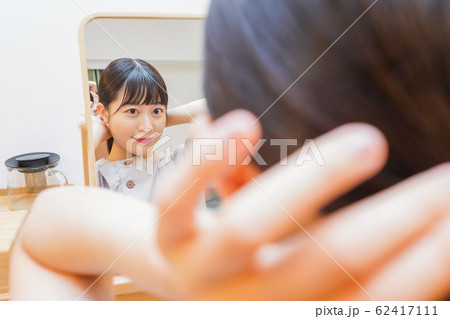 髪のセットをする若い女性 髪のセットをする若い女性 62417111