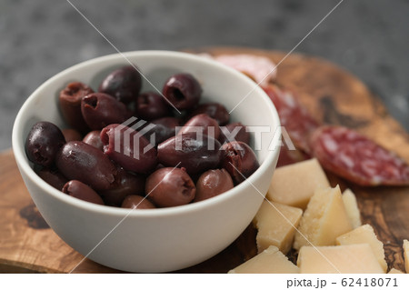 Italian antipasti with cheese olives and sausage on olive wood board Italian antipasti with cheese olives and sausage on olive wood board 62418071