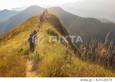 beautiful landscape with trekkers walking mountain ridge in sunset at Khao Chang Phuak Thailand 62418979