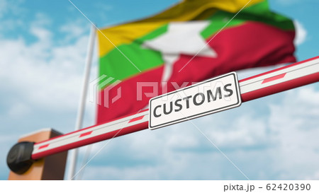 Closing boom barrier with CUSTOMS sign against the Myanma flag. Restricted border crossing or protective tariffs in Myanmar. 3D rendering Closing boom barrier with CUSTOMS sign against the Myanma flag. Restricted border crossing or protective tariffs in Myanmar. 3D rendering 62420390