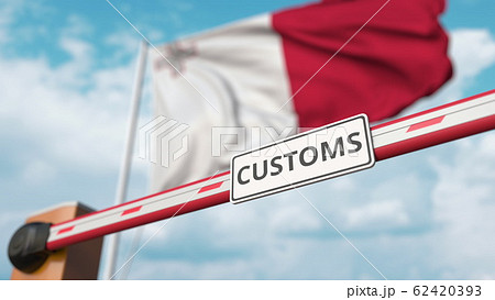 Closing boom barrier with CUSTOMS sign against the Maltese flag. Restricted border crossing or protective tariffs in Malta. 3D rendering Closing boom barrier with CUSTOMS sign against the Maltese flag. Restricted border crossing or protective tariffs in Malta. 3D rendering 62420393