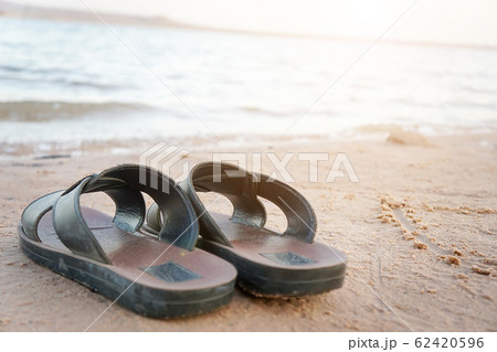 Slippers on the beach in the morning. Slippers on the beach in the morning. 62420596