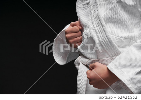 hands closeup - teenager dressed in martial arts 62421552