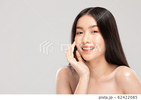 Asian young woman touching soft cheek smile with Asian young woman touching soft cheek smile with 62422085