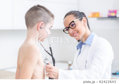 Young female doctor pediatrician examines Young female doctor pediatrician examines 62422643