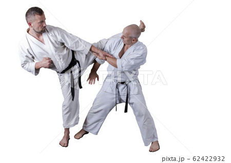 Adult athlete performs formal goju-ryu exercises. Adult athlete performs formal goju-ryu exercises. 62422932