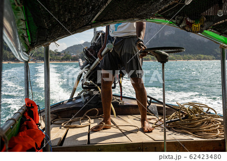 Wooden boat being on the wavy ocean Wooden boat being on the wavy ocean 62423480