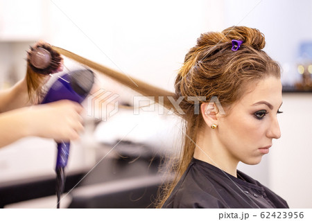 Beautiful young girl at the hairdresser Beautiful young girl at the hairdresser 62423956
