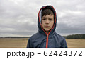 portrait of a serious boy in autumn outdoors, rainy day 62424372
