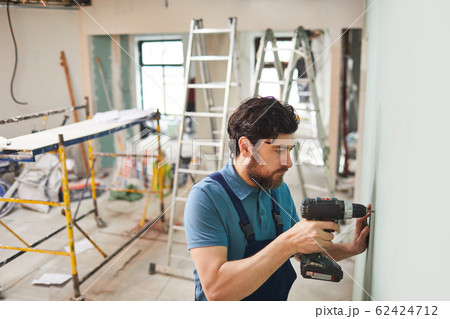 Bearded Man Drilling Wall 62424712