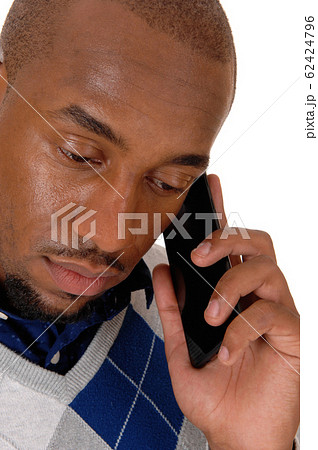 Close-up image of an African man on his cellphone Close-up image of an African man on his cellphone 62424796