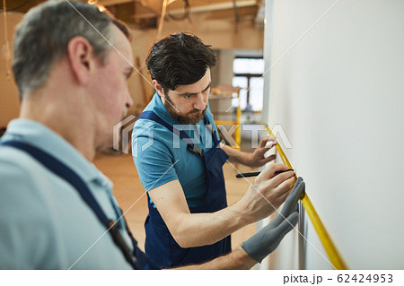 Workers Measuring Wall Workers Measuring Wall 62424953