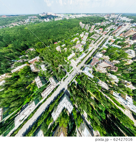 Aerial city view with crossroads and roads, houses, buildings, parks and parking lots. Sunny summer panoramic image Aerial city view with crossroads and roads, houses, buildings, parks and parking lots. Sunny summer panoramic image 62427016
