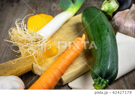 Fresh vegetables ready for cooking shot on rustic wooden table. Fresh vegetables ready for cooking shot on rustic wooden table. 62427179