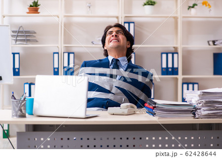 Young tied male employee in the office Young tied male employee in the office 62428644