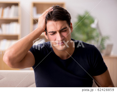 Young handsome man suffering from pain 62428859