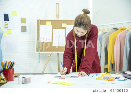 Happy entrepreneur fashion designer in textile 62430110