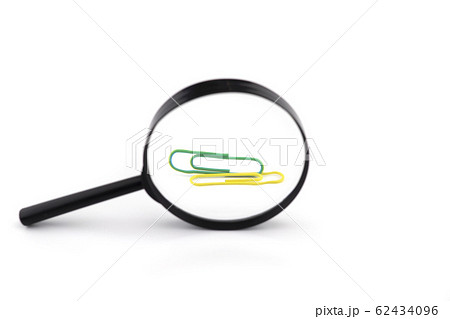Paper clips viewed through a magnifying glass Paper clips viewed through a magnifying glass 62434096