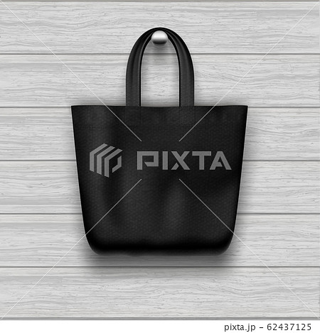 Textile textured black tote bag hanging on the wooden plank textured wall. 62437125