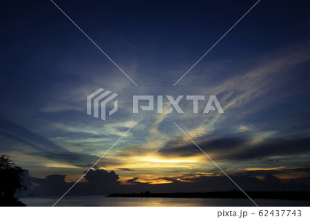 sea during sunset with cloudy sky 62437743