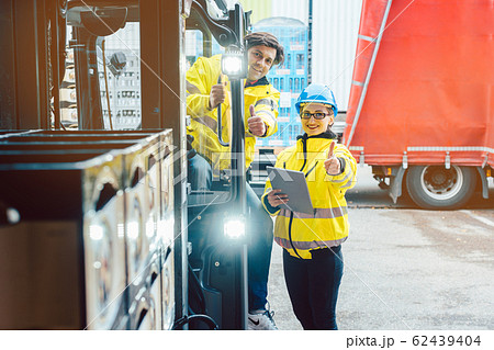 Forklift driver and forewoman discussing where to store delivery Forklift driver and forewoman discussing where to store delivery 62439404