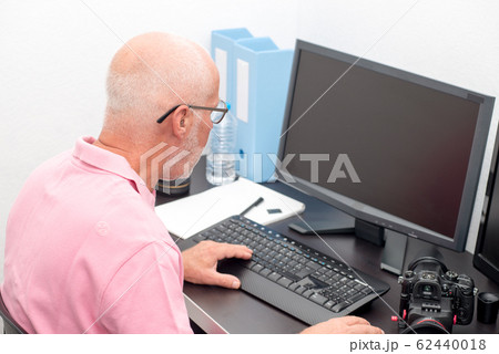 mature man working with computer at office mature man working with computer at office 62440018