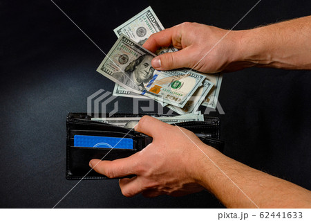 Man on black background holds in his hands a Man on black background holds in his hands a 62441633