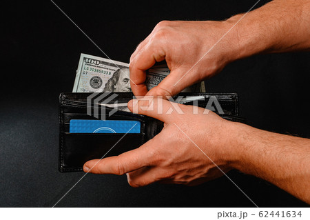 Man on black background holds in his hands a 62441634