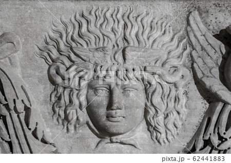 Medusa face sculpture. Head portrait of MedusaIn Greek mythology Medusa was a monster, a Gorgon, a winged human female with a hideous face and living venomous snakes in place of hair Medusa face sculpture. Head portrait of MedusaIn Greek mythology Medusa was a monster, a Gorgon, a winged human female with a hideous face and living venomous snakes in place of hair 62441883