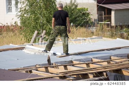 Workers cut the roof in the house 62448385